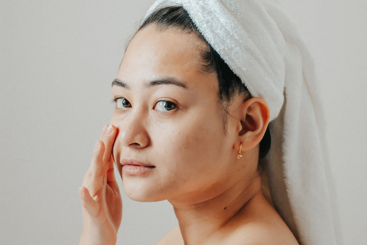 Skincare model applying moisturizer