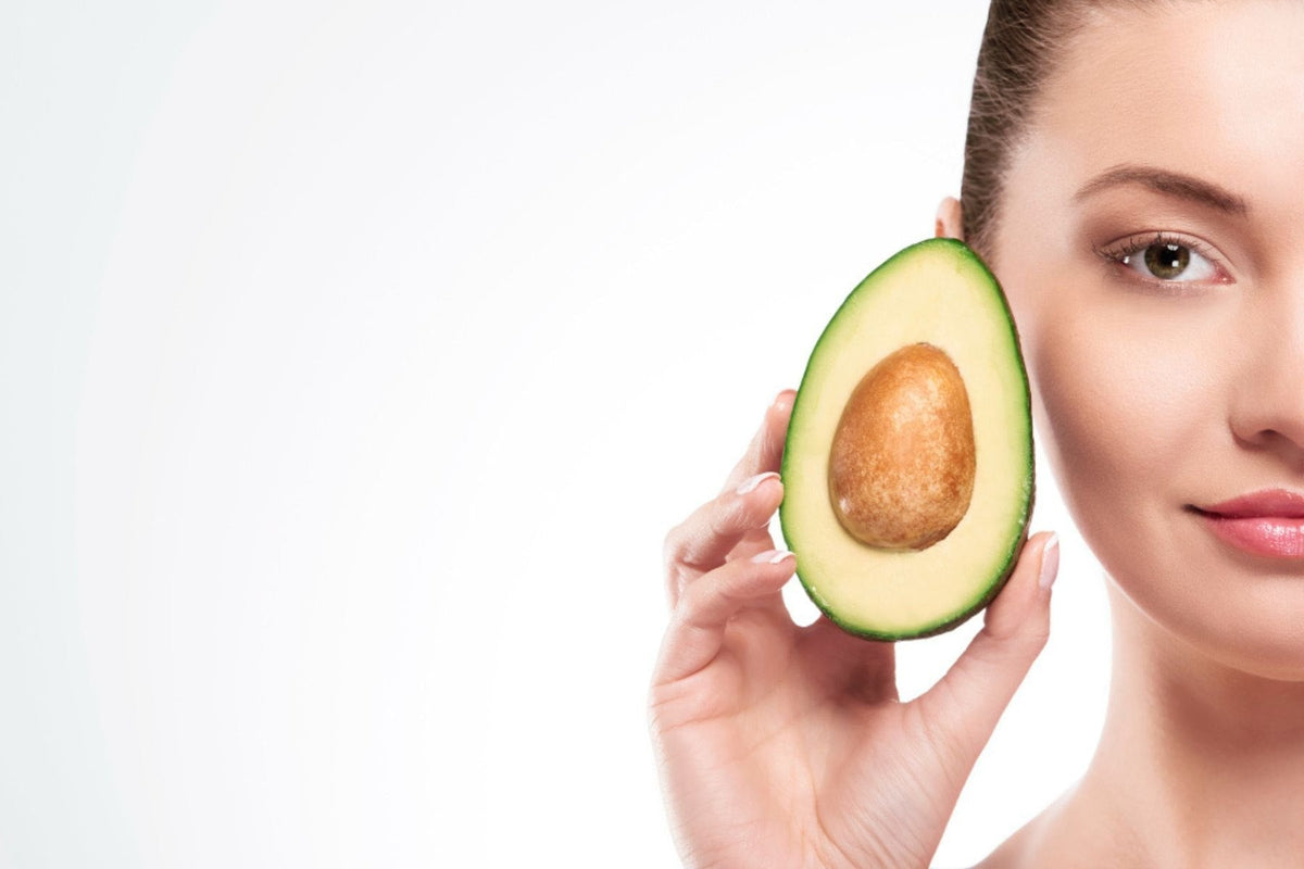 Portrait of woman with avocado
