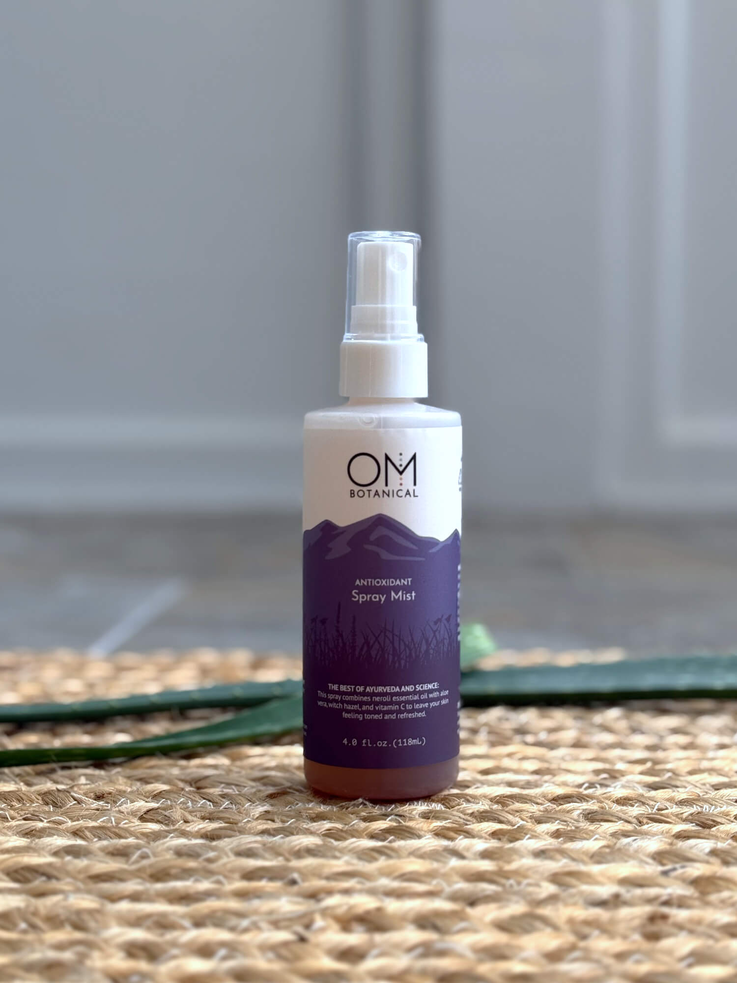 Antioxidant Spray Mist Toner - Lifestyle on a straw mat with aloe | OM Botanical