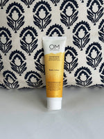 Body Lotion - lifestyle on a couch scene | OM Botanical