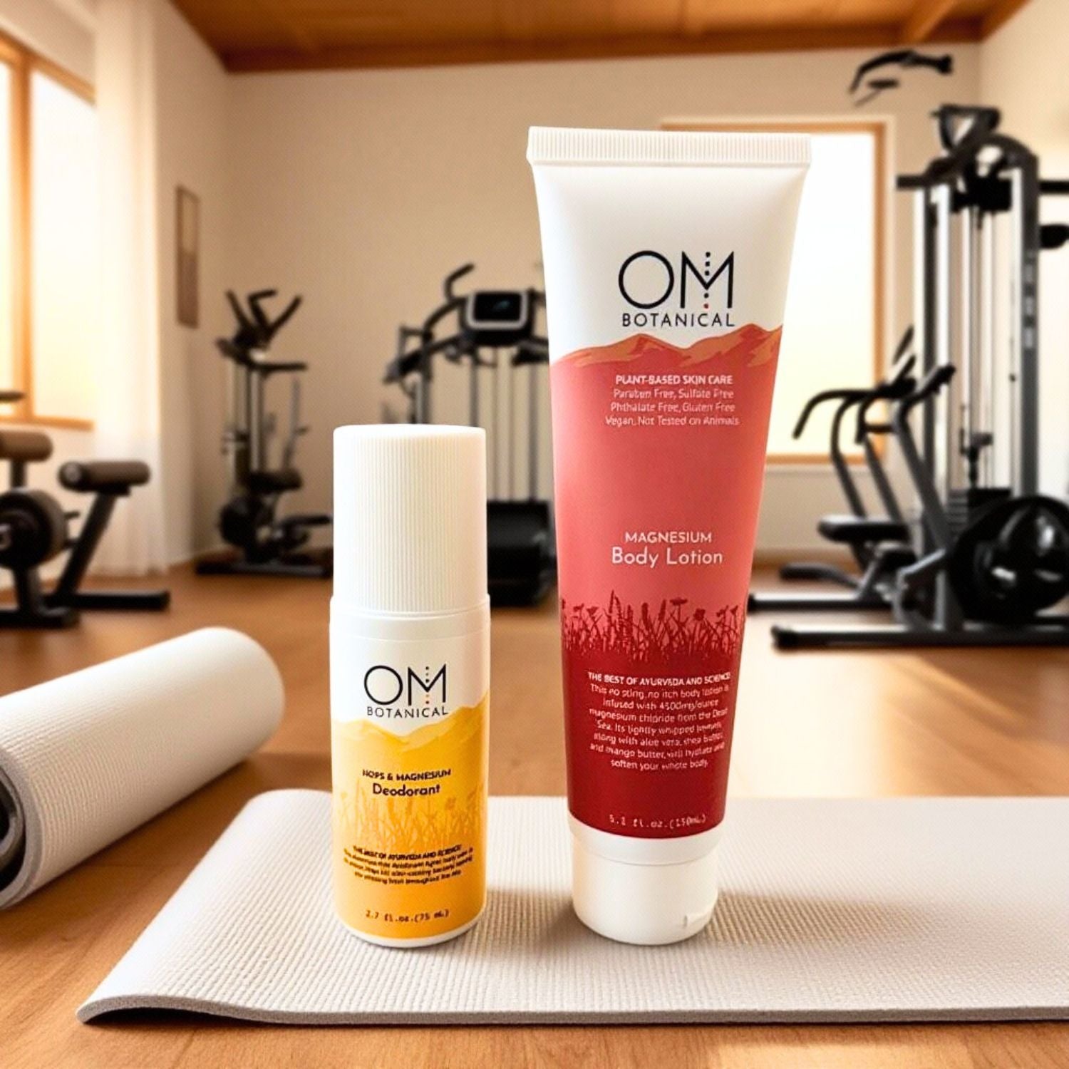 Active Recovery Duo with magnesium body lotion and natural deodorant by OM Botanical, displayed on a yoga mat in a gym setting.