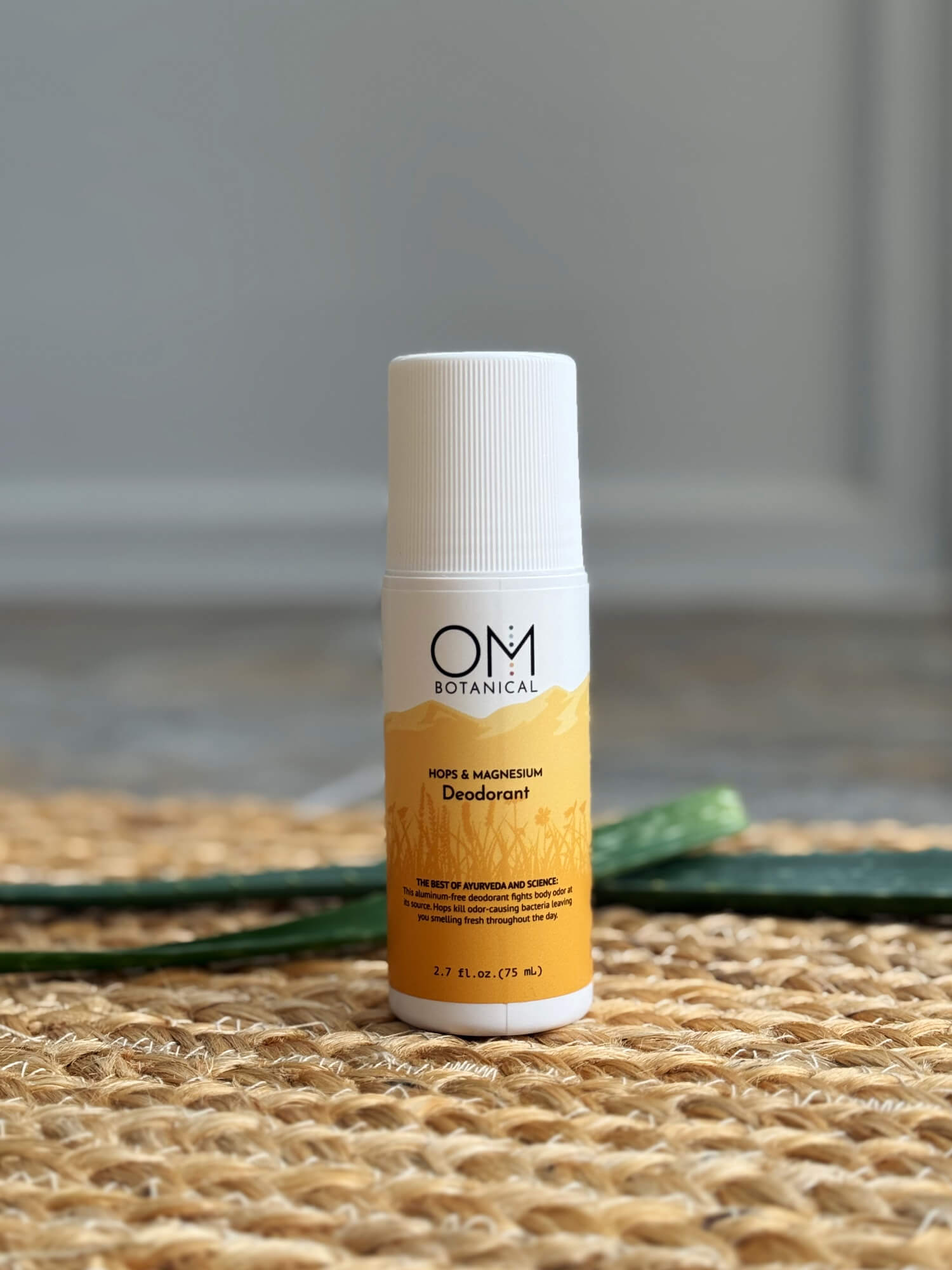Deodorant - lifestyle on a straw mat with aloe leaves | OM Botanical