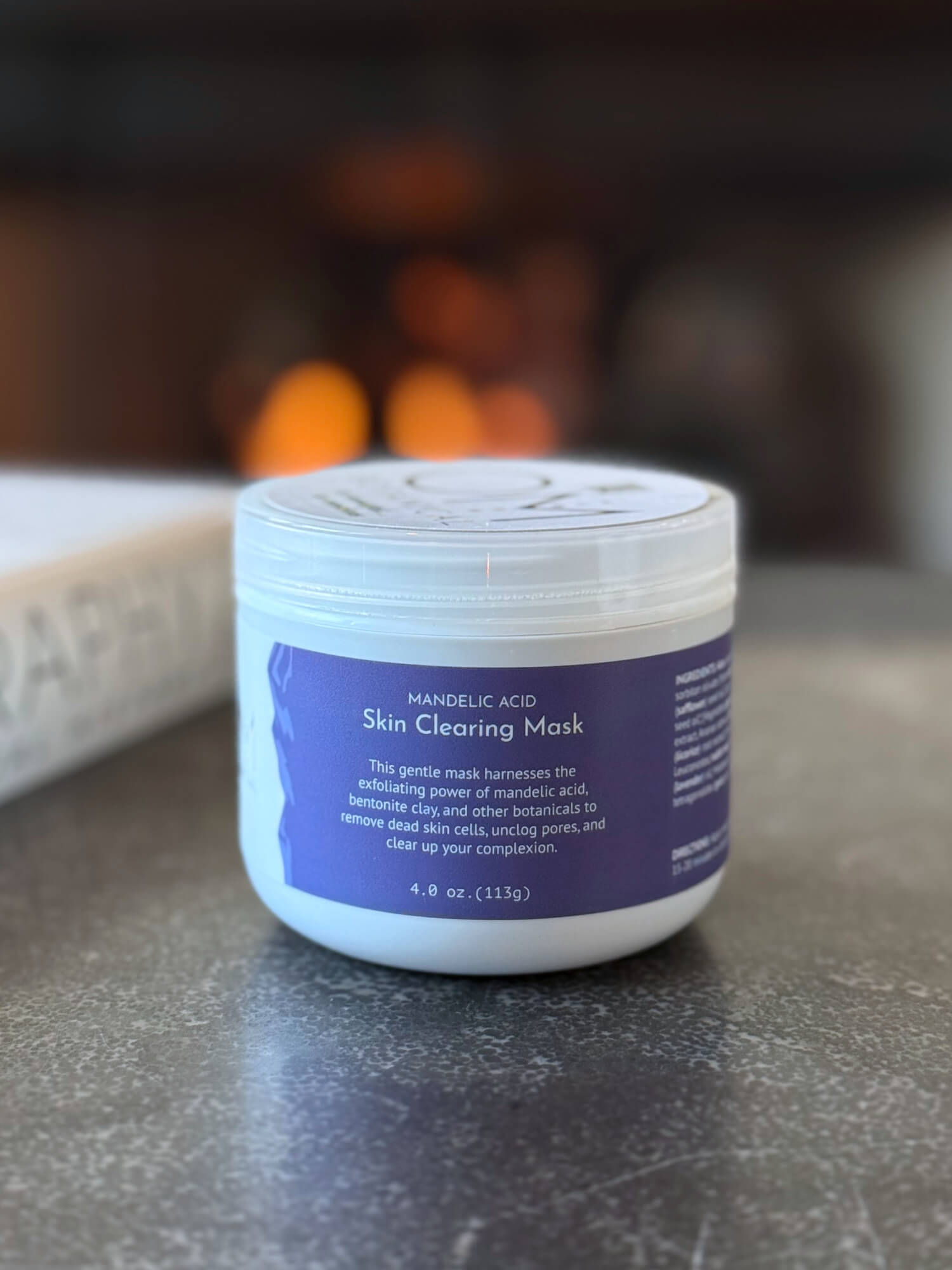 Mandelic Acid Mask - lifestyle on table by fireplace | OM Botanical
