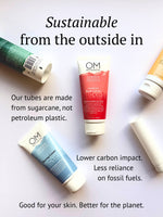 OM Botanical tubes made from carbon neutral sugarcane shown on a white surface, emphasizing lower fossil fuel use