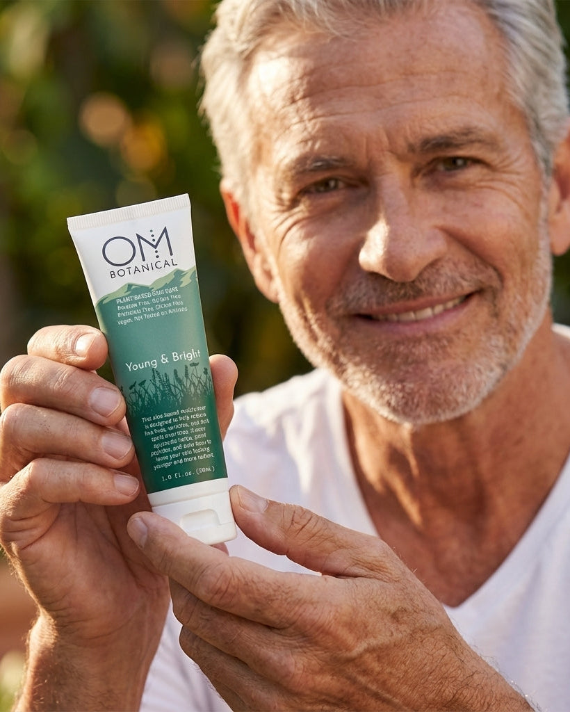 Man holding a tube of OM Botanical Young and bright outdoors